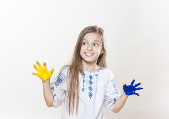 Young girl in embroidery with hands yellow and blue colors