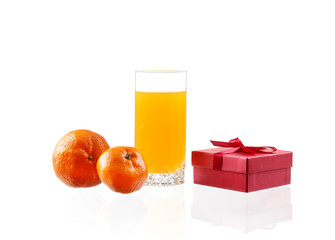 Orange juice in a glass with lime, orange, tangerine box