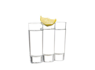 Three  tequila shots with lime isolated on white background