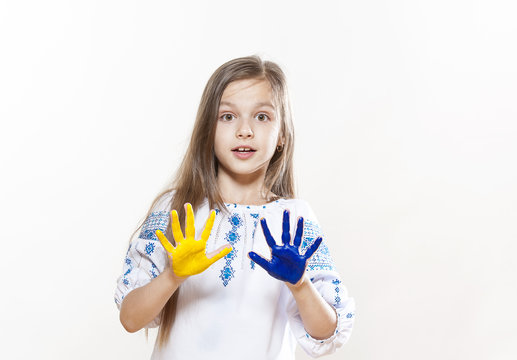 Young girl in embroidery with hands yellow and blue colors