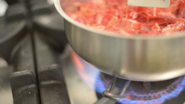cooking king shrimp in pan 
