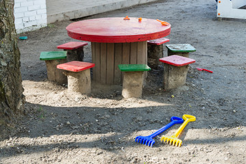 Table, stools, toys on the playground
