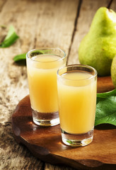 Pear fresh juice and pear on a wooden table, selective focus