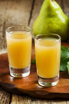 Pear fresh juice and pear on a wooden table, selective focus