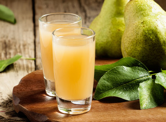 Pear fresh juice and pear on a wooden table, selective focus