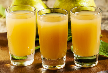 Pear fresh juice and pear on a wooden table, selective focus