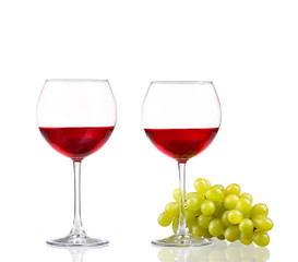 Glass of red wine and white grapes isolated on white 
