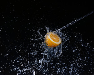 Fototapeta na wymiar A high-speed shot of a lemon with splashing 