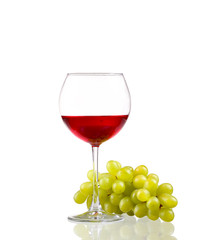 Glass of red wine and white grapes isolated on white 