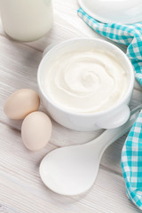 Obraz na płótnie Canvas Sour cream in a bowl and eggs