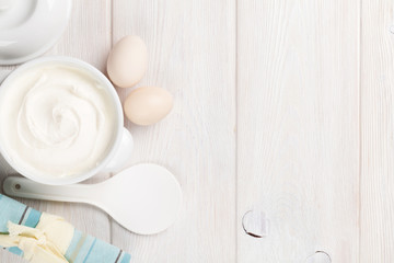 Fototapeta na wymiar Sour cream in a bowl and eggs