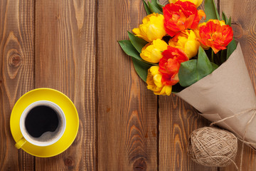 Fototapeta na wymiar Colorful tulips bouquet and coffee cup