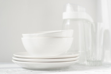 white plates and bowls on light table