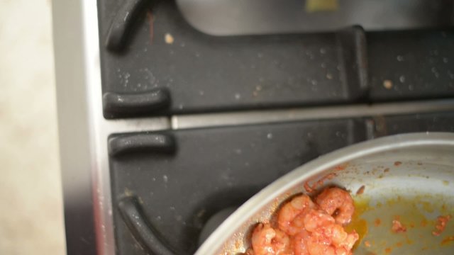 cooking king shrimp in pan 
