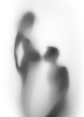 Pregnant woman and man together, silhouette