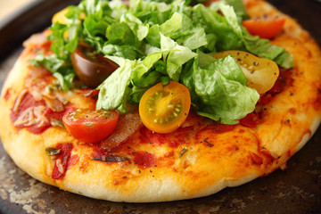 Pizza with bacon, lettuce and fresh tomatoes