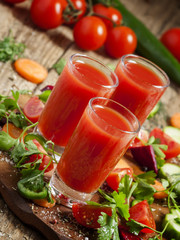 Fresh red vegetable cocktail decorated with vegetables and spice