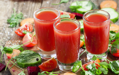 Fresh red vegetable cocktail decorated with vegetables and spice