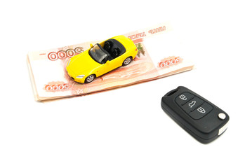 banknotes, keys and yellow car