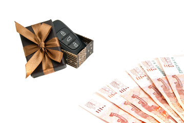 car keys, banknotes and brown gift box
