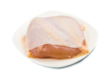 Fresh heart shaped skinless chicken breast meat on a plate