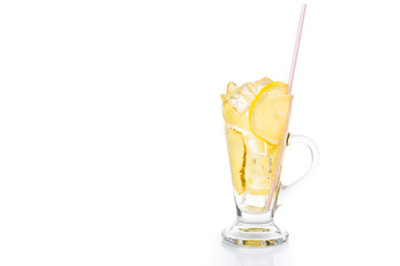 Refreshing ice cold ginger lemon tea in transparent glass