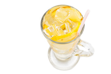 Refreshing ice cold ginger lemon tea in transparent glass