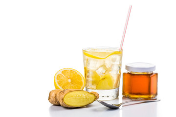 Refreshing ice cold honey lemon and ginger tea in glass