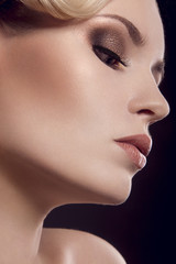 Fototapeta premium Beautiful blonde girl with perfect skin. Picture taken in the studio on a black background