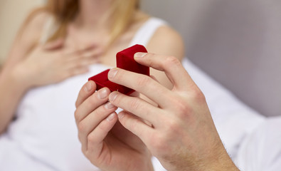 close up of hands holding little red gift box