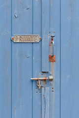 Private sign on blue gateway to proprety