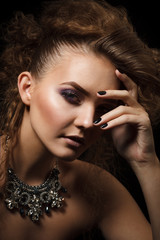 Obraz premium Studio shoot of beautiful woman with bright makeup and creative