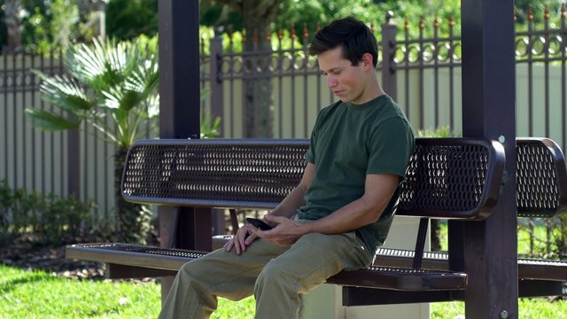 Young man cracks a smile after looking at his phone, WIDE, 4K