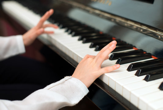 Child learning to play the piano.