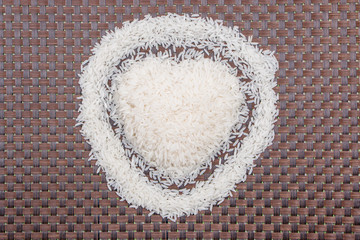 Raw rice on bamboo background