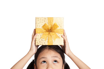 Little asian girl with gift box over her head