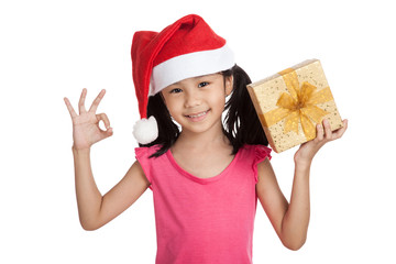 Little asian girl with santa hat and gift box show OK