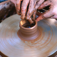 Hands working on pottery wheel