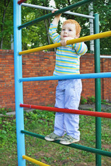 The little boy on swedish wall outdoors