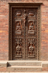 Old carved wooden door in Nepal. National art of curving
