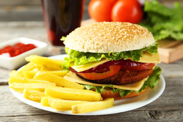 Fresh burgers on plate on grey wooden background