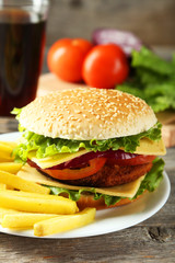 Fresh burger on plate on grey wooden background