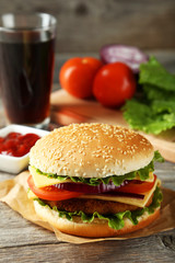 Fresh burgers on grey wooden background