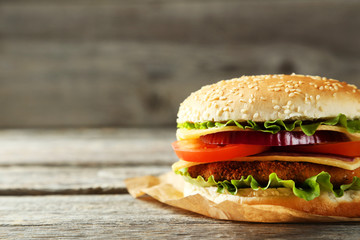 Fresh burger on grey wooden background