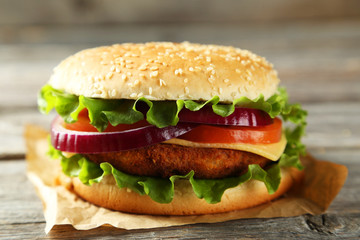 Fresh burger on grey wooden background