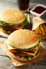Fresh burgers on grey wooden background