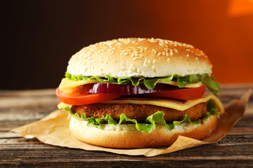 Fresh burger on brown wooden background