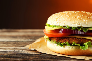 Fresh burger on brown wooden background