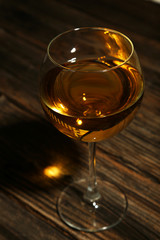 White wine glass on brown wooden background