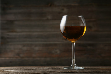 White wine glass on grey wooden background